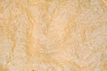 Crumpled Beige paper texture. For background or wallpaper. Flat lay, top view.