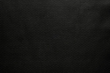 The background dense black modern durable fabric with a pronounced texture pattern