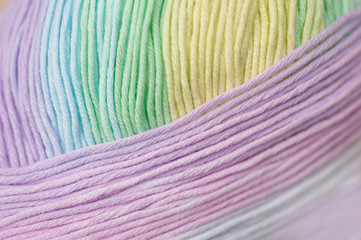 Abstract of skein of mixed pastel colored acrylic threads in a roll with selective focus