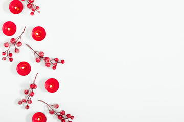 Christmas holiday composition. Xmas decorations, candles, berries on white background. Christmas, New Year, winter concept. Flat lay, top view, copy space