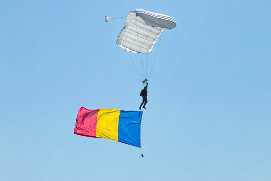 OSTRAVA, CZECH REPUBLIC - SEPTEMBER 22, 2019: NATO Days. Paratrooper descends after an airdrop over the airport, with Czech flag attached to him.