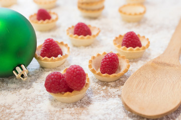 natural raspberry cakes or candies with christmas ornaments