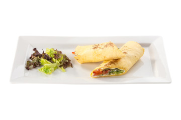 fresh tortilla wraps with vegetables on white plate isolated on white background