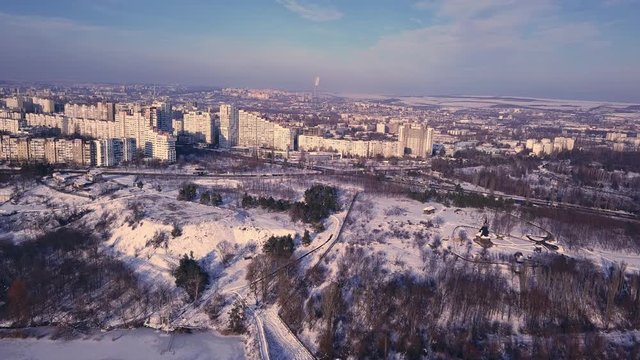Top view of city in winter at sunset on sky background. Aerial drone videography concept. 4K. Kishinev, Republic of Moldova.