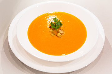 Pumpkin and carrot soup in a bowl