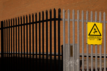 two tine metal raling and danger sign
