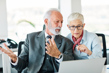 business office person discussion laptop problem worried teamwork senior meeting