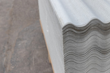 Many gray slate sheets are stacked on top of each other. Wavy stripes pattern