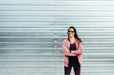 Fototapeta premium Portrait of beautiful woman ready for workout in the street. Sport training concept.