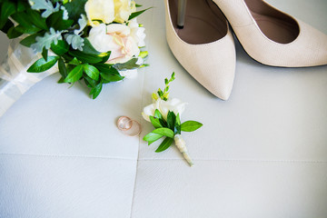 Wedding accessories: shoes, rings, boutonnieres, perfume on white background