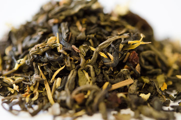 Green tea with additives closeup on white background. Proper nutrition, healthy tonic drink.