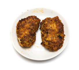 Grilled meat patties on a plate isolated on a white background.