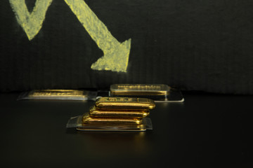 Falling gold prices in global markets. Speculation, futures contracts, gold bullion. Black...