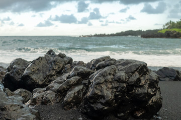 Fototapeta na wymiar black rocks on the beach