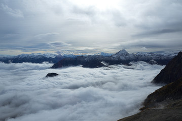 Mont Blanc. Aerial view of the Alps surrounded by clouds.