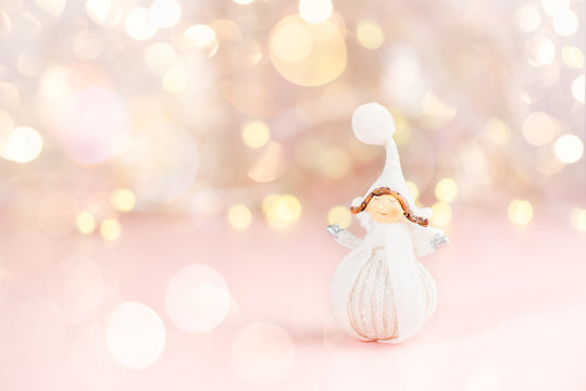 Close up of tiny pretty Angel dresses in white winter cloth