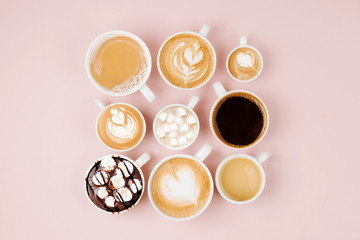 Various kinds of coffee in cups of different size   on pale pink background.  Coffee  Time concept.  Flat lay, top view
