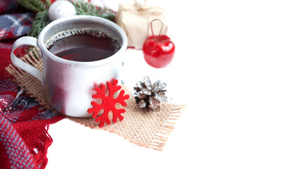 Hot christmas beverage black tea in mug with new year decorations, Cone, present, silver ball, apple, plaid on white background. Winter time top view. Christmas mood