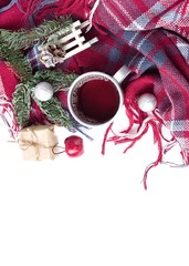 Hot christmas beverage black tea in mug with new year decorations, Sledge, present, balls, plaid on white background. Winter time top view.
