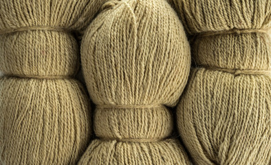 The texture of the wool yarn. Skeins of wool yarn in threads for knitting clothes.