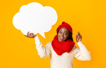 Cheerful afro girl with communication bubble pointing finger up