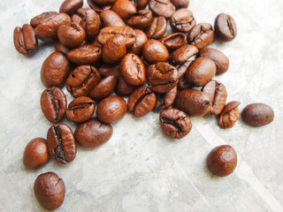 roasted coffee beans on a gray background, can be used as a background. large grains of coffee