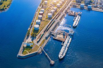 Aerial view large port oil loading terminal with large storage tanks. Railway infrastructure for...