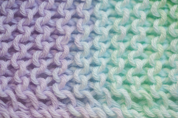 Fragment of handmade seamless knitted patterns in mixed pastel colors  closeup