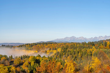 Wide view of beautiful autumn landscape with High Tatra Mountains in background, Slovakia..