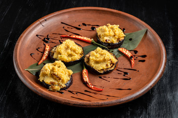 Pumpkin puree is laid out on grilled eggplant.