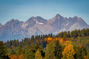 Wide view of beautiful autumn landscape with High Tatra Mountains in background, Slovakia..