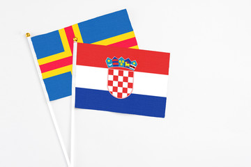 Croatia and Aland Islands stick flags on white background. High quality fabric, miniature national...