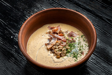 Lentil soup with smoked products in a bowl.