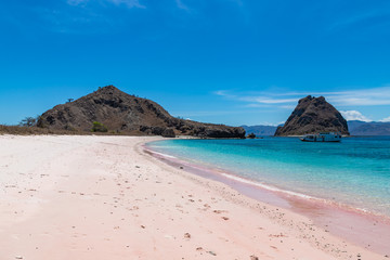 Fototapeta na wymiar Long pink beach on Padar island. Deserted beach with pink sand. Komodo National park, Flores, Indonesia