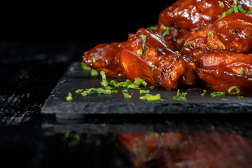 Chicken Wings with tomato barbecue sauce. Sprinkled with dill, onions and parsley.