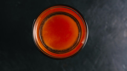 Top view. Vodka with tomato juice in a glass on a dark background