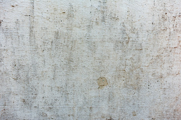 Texture of a concrete wall with cracks and scratches which can be used as a background