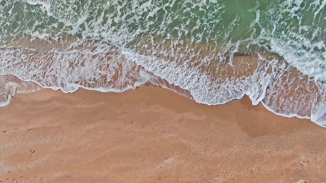 AERIAL SHOT General beaches CRIMEAU KERCH SEPTEMBER 2019 SEA of AZOV top view of the tide with green waves and yellow shore