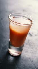 Cool Vodka with tomato juice in a short glass.