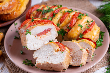 Chicken fillet baked with tomatoes and cheddar cheese