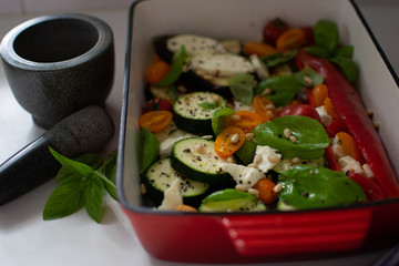 fresh oven grill dish with cherry tomatoes basil courgette red pepper and mozzarella