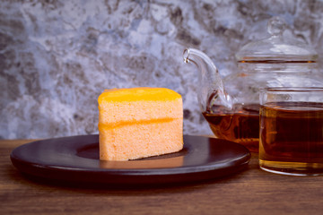 Orange cake and teapot.