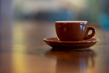 Colored coffee cup on shelf