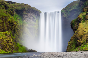 Scenic view of Skogafoss waterfall on cliff, South Iceland, Iceland
