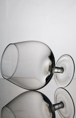 Short-stemmed wine glass. Lies on its side, photographed in the light.