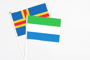 Sierra Leone and Aland Islands stick flags on white background. High quality fabric, miniature...