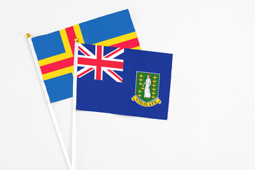 British Virgin Islands and Aland Islands stick flags on white background. High quality fabric, miniature national flag. Peaceful global concept.White floor for copy space.