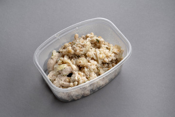 Oatmeal with chicken breast in a plastic container. Convenient to take with you.