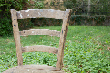 Close-up on a Workshop Chair Back Against a Grassy Background