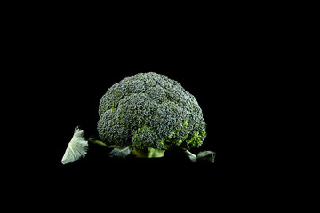 Fresh green broccoli, a type of cauliflower. Isolated on a black background.